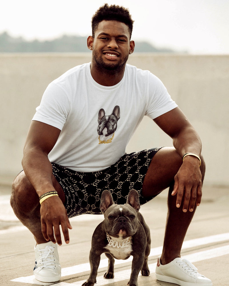Juju wearing the white boujee tee with his dog in the photo